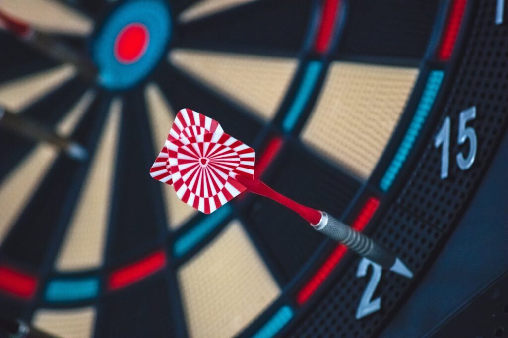 pexels-photo-262438 A dart striking the bullseye on a dartboard, showcasing precision and accuracy.
